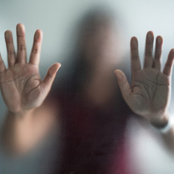 invisible_woman_behind_glass_barrier